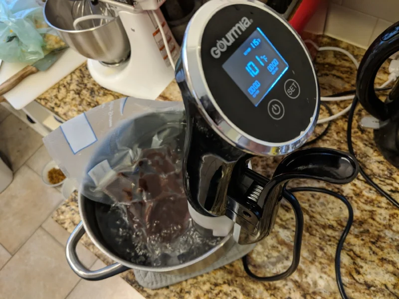 The sous vide bath is used to precisely raise and lower the temperature of the chocolate to promote correct crystalline growth, tempering the chocolate. Improperly tempered chocolate is soft and melts in your hands making a mess.