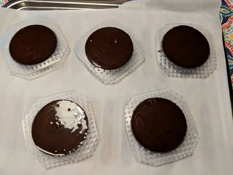  The tempered chocolate was poured into the vacuum formed molds. 