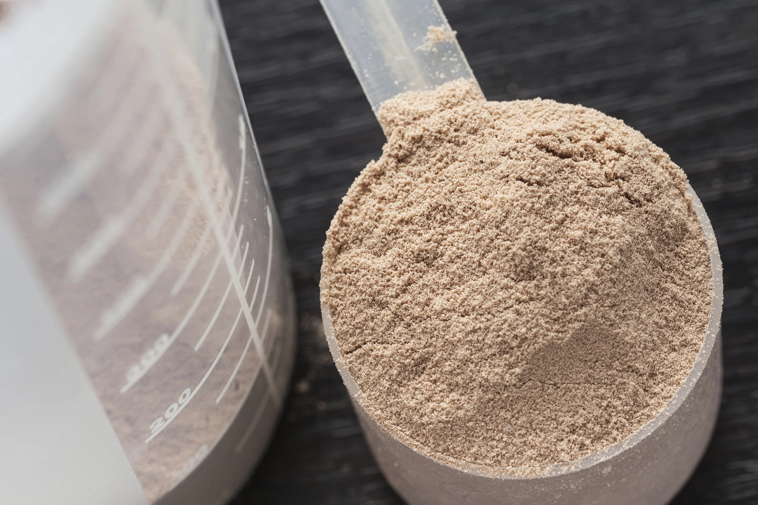 Scoop of chocolate whey isolate protein - 465163645.jpg