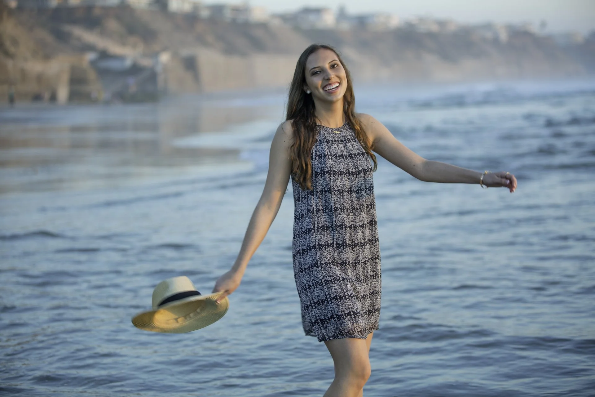 Young woman happy on beach at sunset