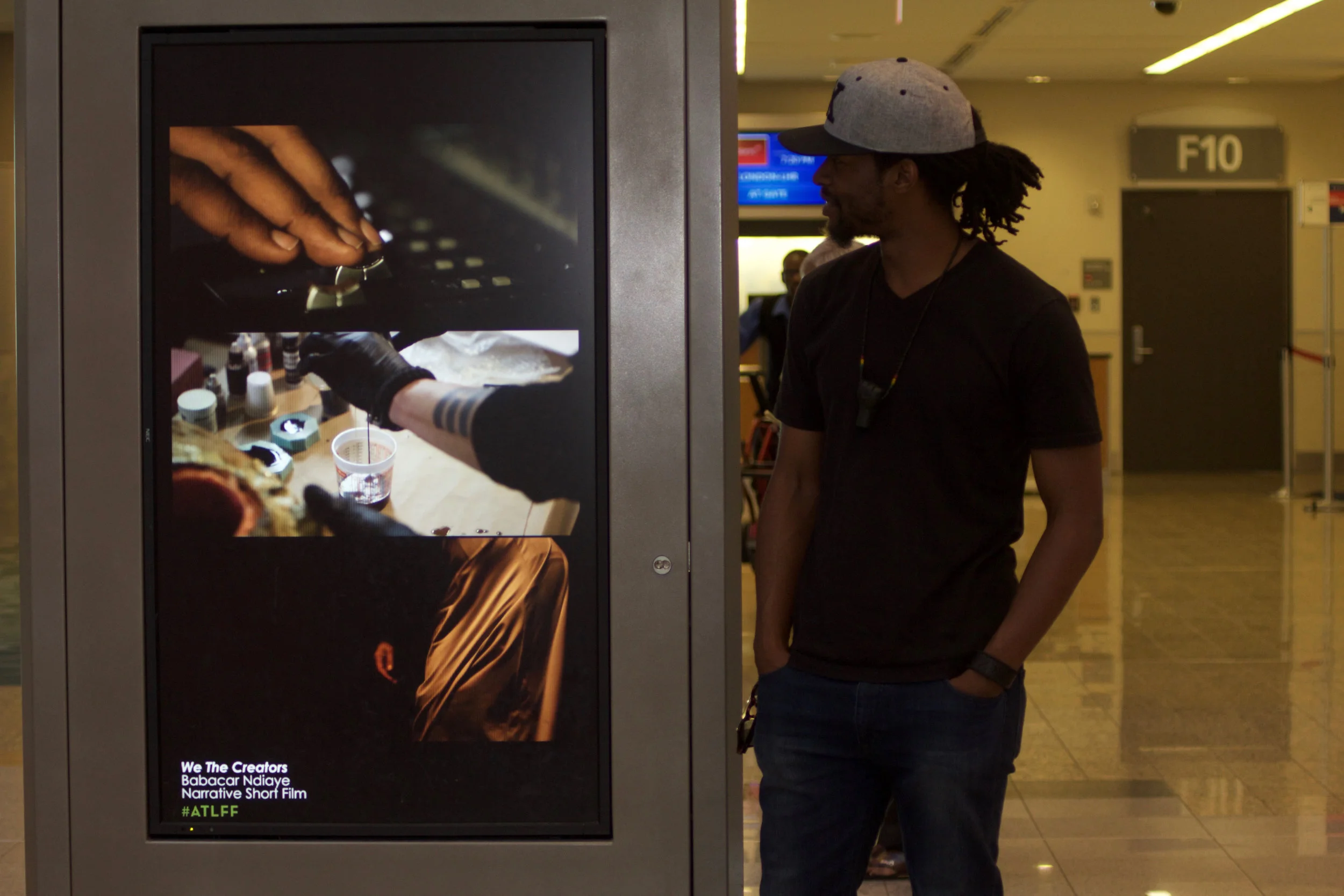 FILMMAKER-IN-RESIDENCE BABACAR NDIAYE PICTURED WITH HIS AIRPORT SHORT, WE THE CREATORS