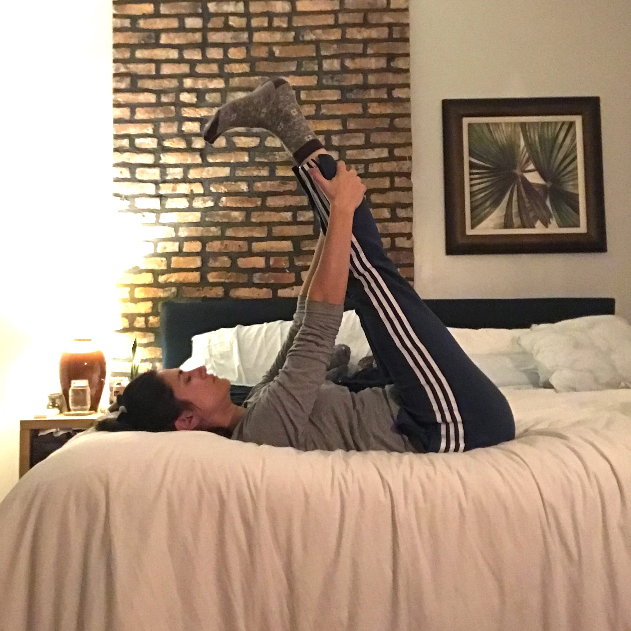 8. After hanging with feet up for a while, flex your feet (pressing your heels upward) and gently grab onto your legs. Keeping your tailbone down, draw your legs towards your chest for one final stretch. Hold for 5-10 slow breaths.