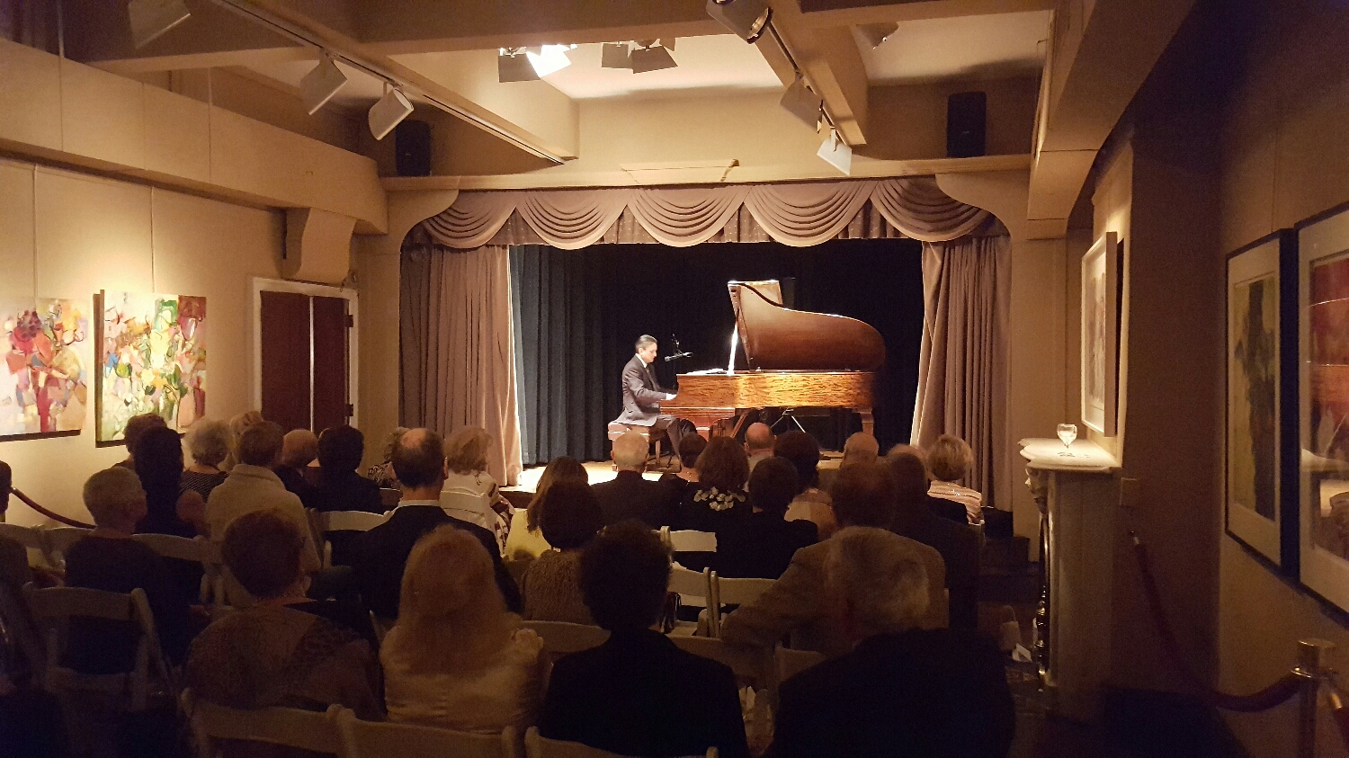 Solo jazz piano and vocals in a relaxed and elegant environment, with a supportive audience.