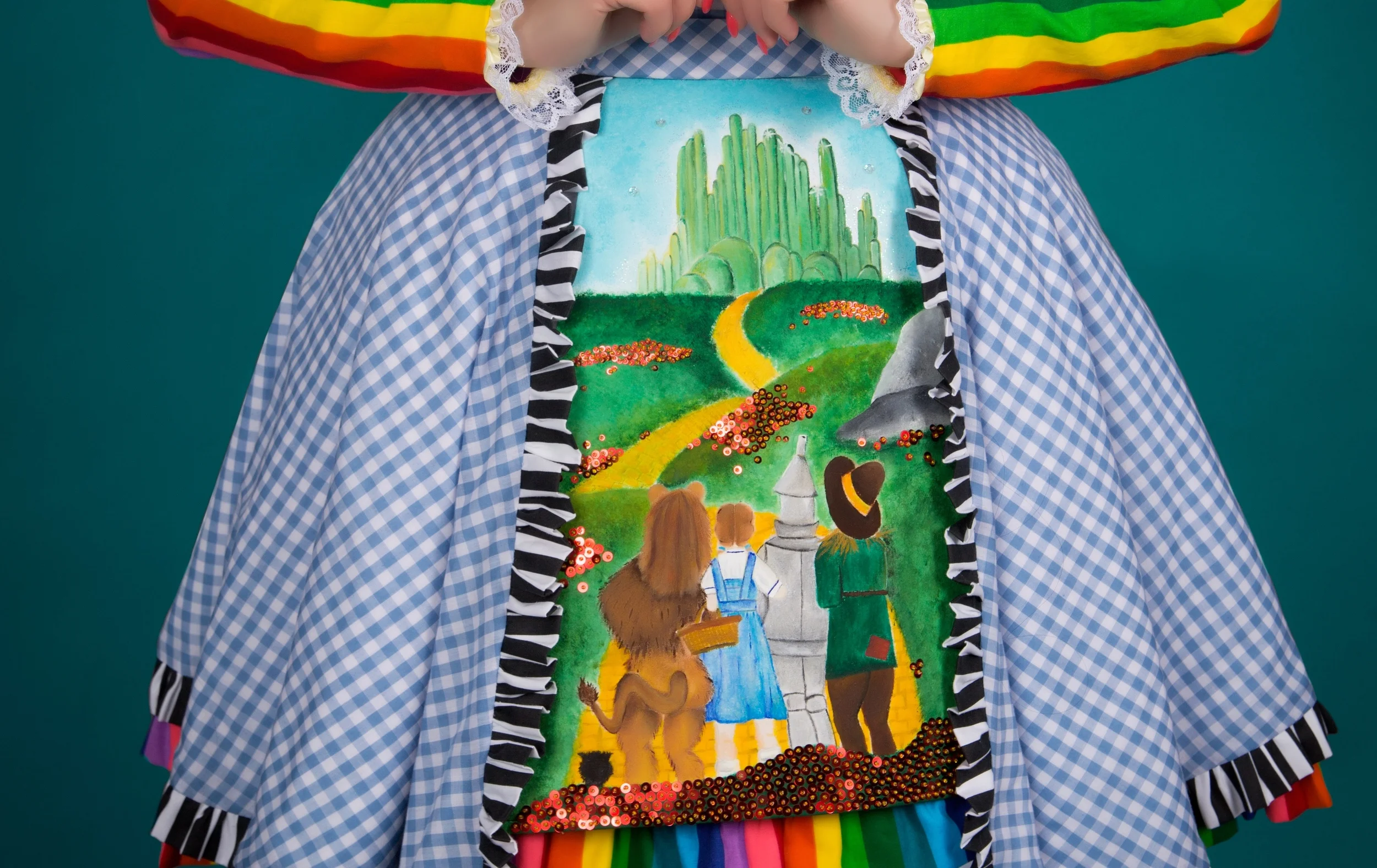  The front of Ebony Amber's Oz dress was hand painted by Ebony. &nbsp;Amber also beaded sequins on top to create the look of poppies.&nbsp; 