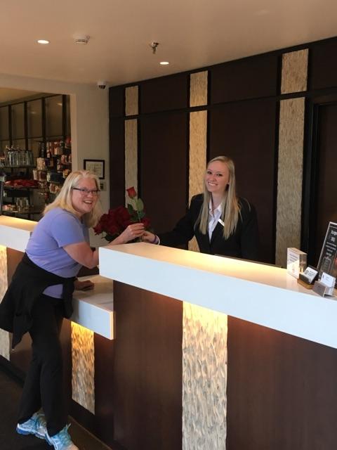 Front desk agent Hadli handing out flowers to our guest for Mother's day.