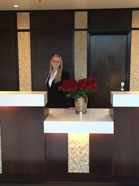 Front desk agent Hadli getting ready to hand out flowers for Mother's day.