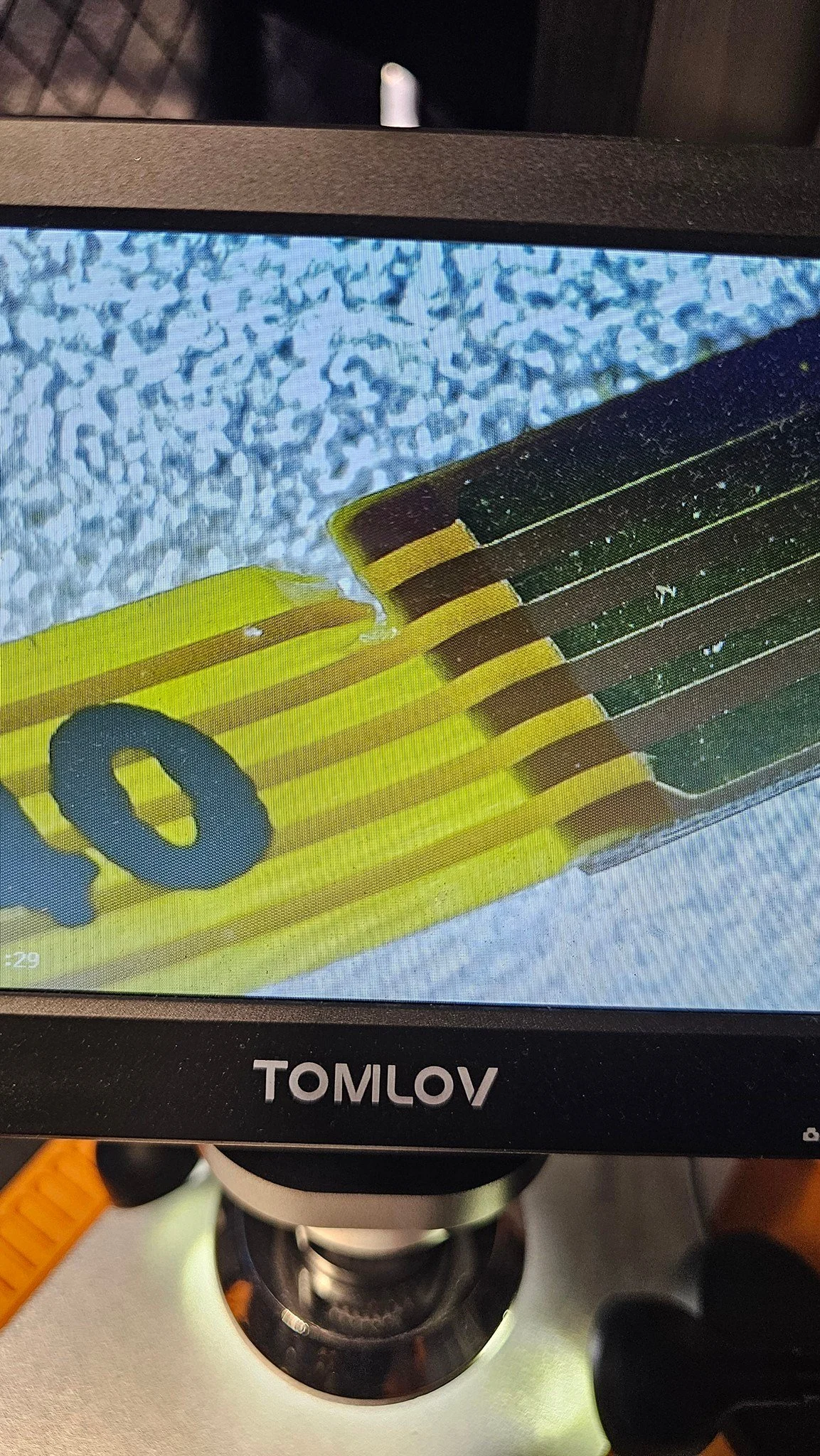 It may not be pretty, but it's connected.

Got a thing in the mail and noticed it was acting strange. No real hope in an exchange or refund, so I decided to fix it myself.

Just so you know, the ribbon cable is only 3mm wide and the jumper wire is 0.