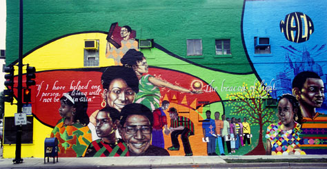 Beacon of Light , a mural combining acrylic paint and spray paint by Rahmaan Barnes, assisted by Max Sansing with youth team. 2006.