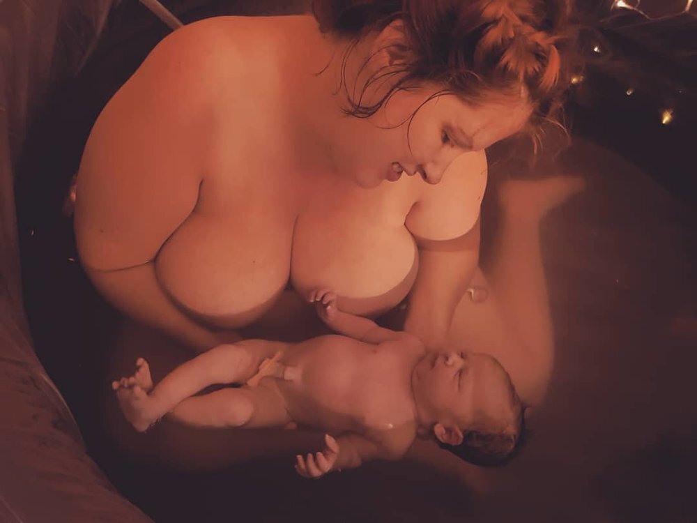 Birth in all it's wondrous, sacred normality. Photograph taken by myself as a doula at this intimate home birth. Shared with kind permission.