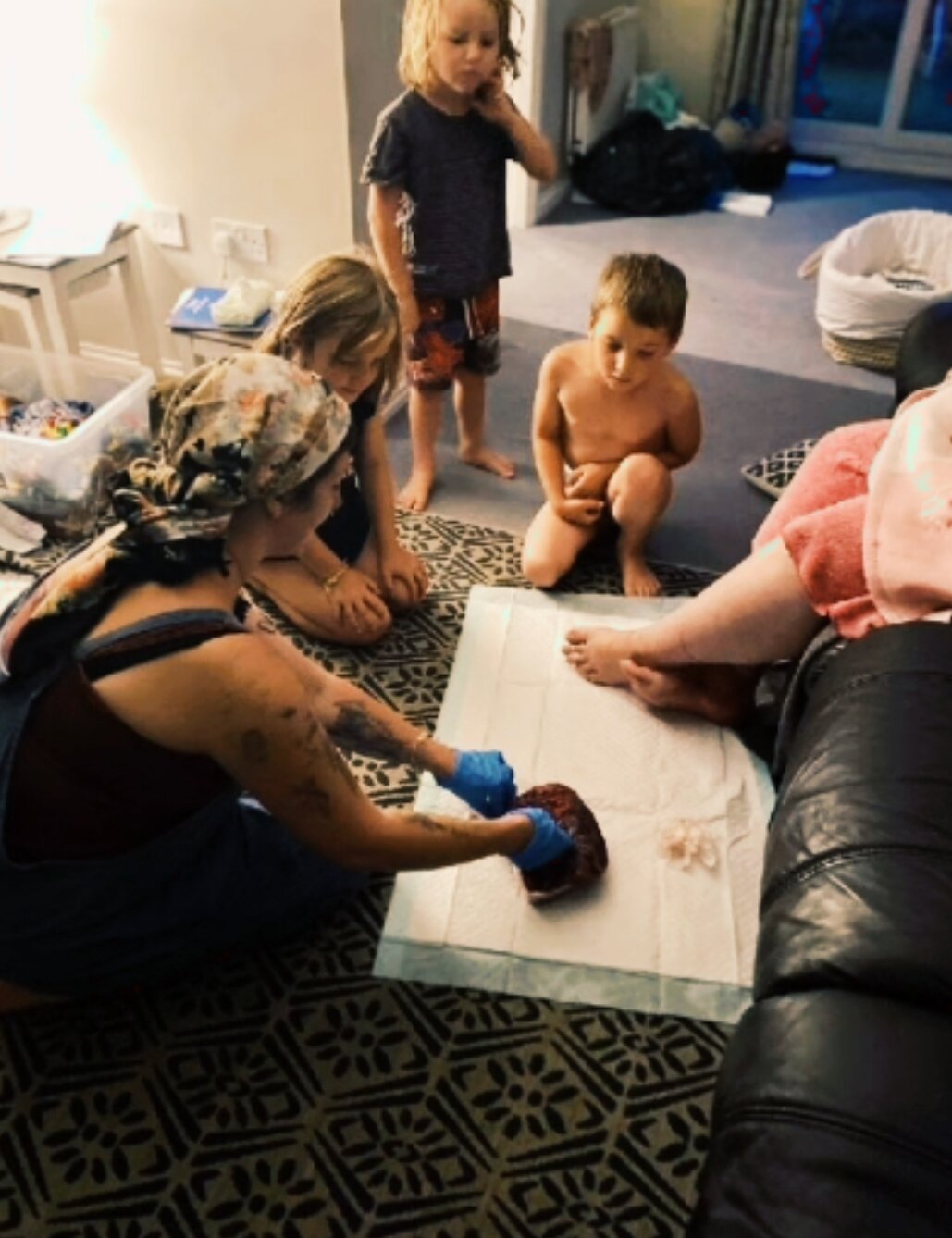 Giving a placenta lesson at a beautiful family-centred unassisted birth