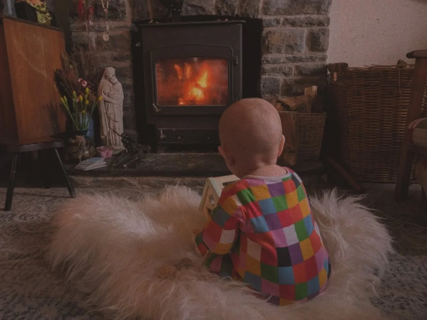 the cusp of spring is daffs in a vase and a roaring fire as it pours outside