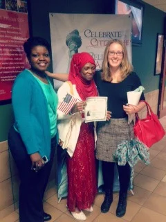 aimee zangandou from LSG's Refugee Services Department and ashley lariccia from LSG's Immigration department pose with monica Sherrif at her naturalization ceremony