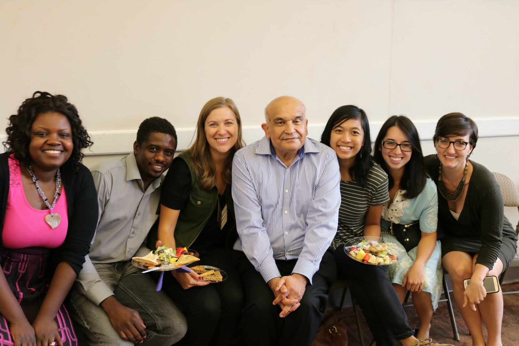 obaid surrounded by members of the refugee services staff.