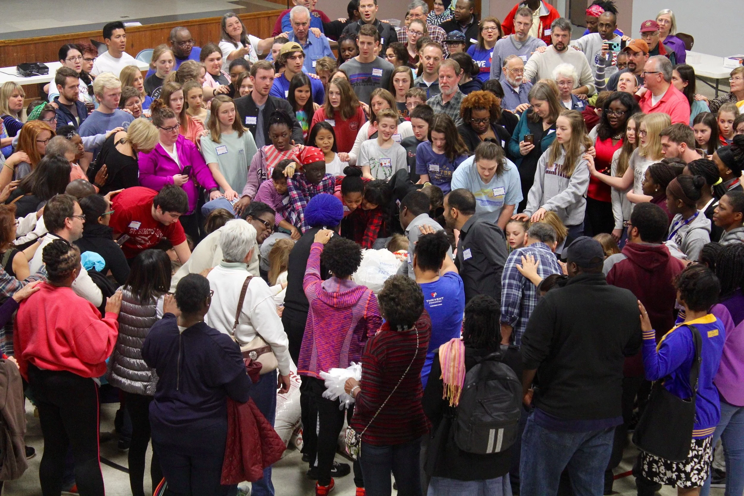 Volunteers join in blessing the 4,200 lbs of donated rice.
