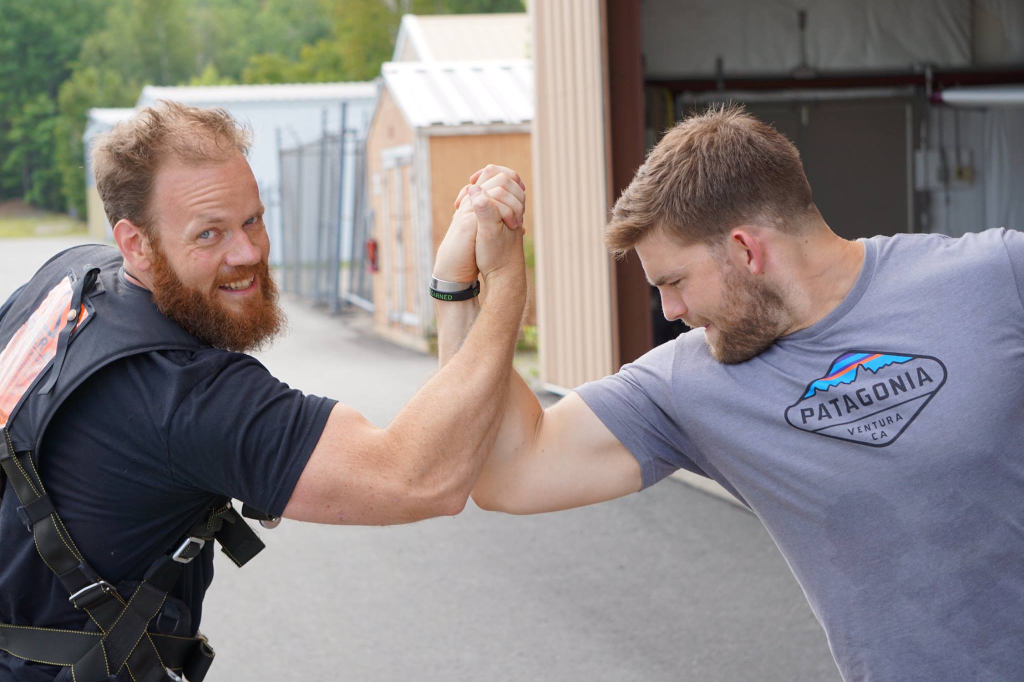 Obligatory post-skydive "Predator" style embrace. "Dillon, you son of a..."