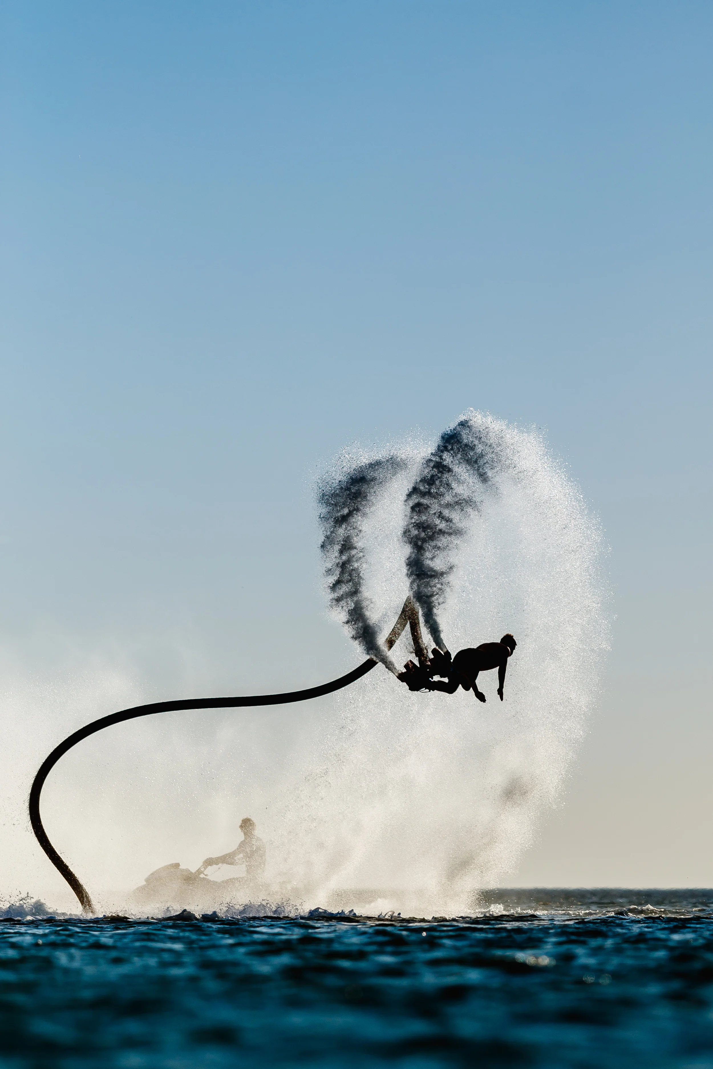 Silhouette of a fly board rider