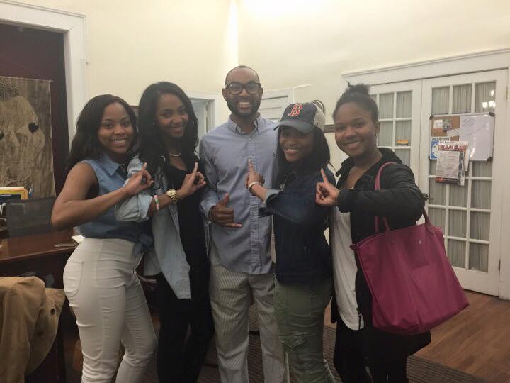 Members of the Lambda Upsilon Chapter posing with Kenny Rice (Alpha Phi Alpha) after an event in Harambee House 
