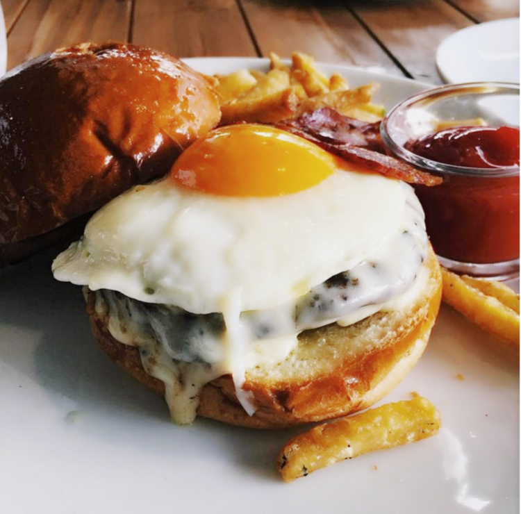 The Burger – jack cheese, farmers’ market fried egg, sweet and spicy bacon, brioche, herbed crispy fries