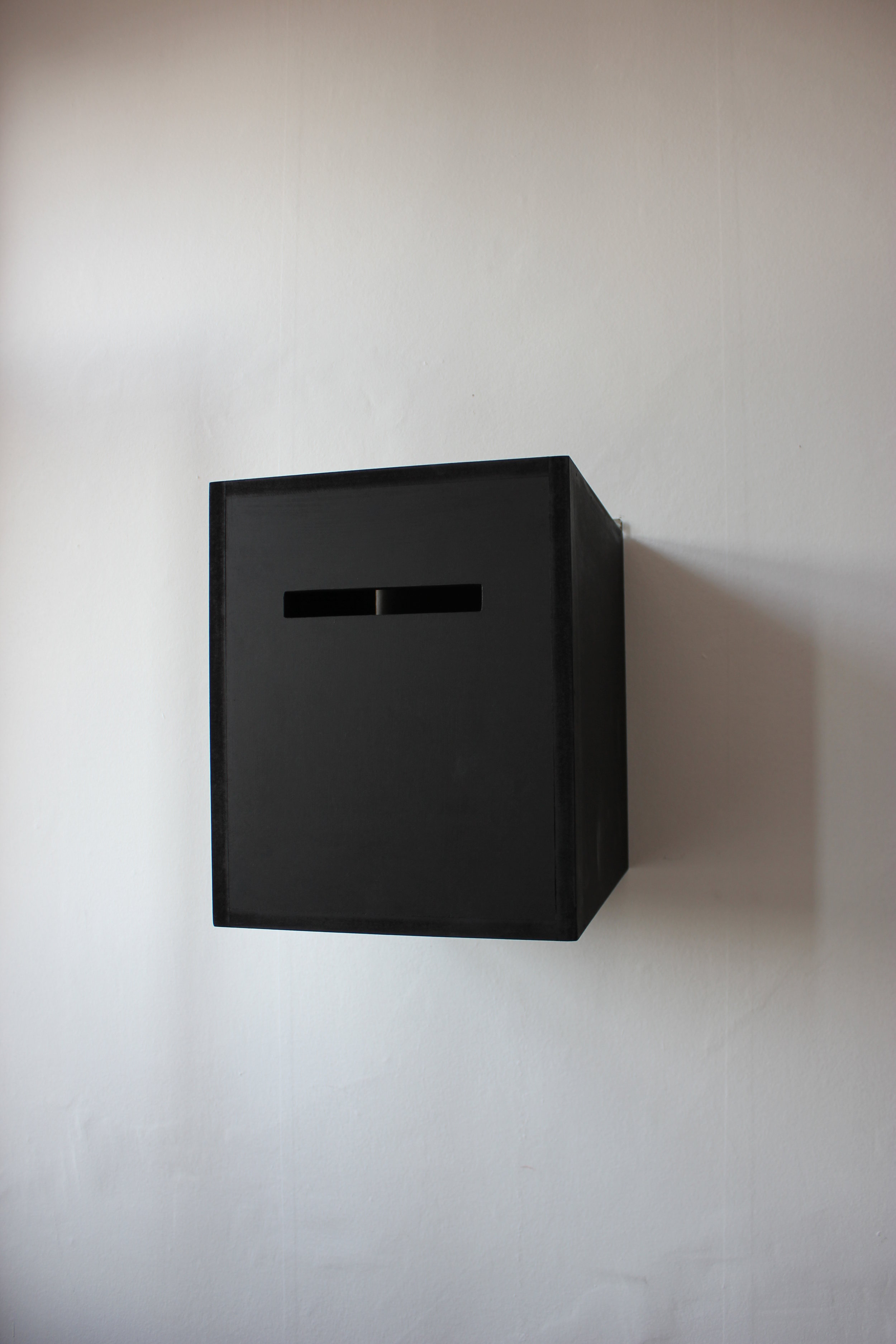  Box of smiling eyes, 2014.&nbsp;  31x38x40 cm  Closed painted wooden box with a small peephole to look inside the box and see your own eyes reflecting in a mirror and the word SMILE.    