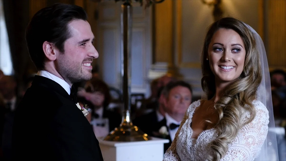 Phil and Emma make their vows to one another in the stunning ceremony room at Knowsley Hall. With light pouring in from the tall window at the front of the ceremony hall, Phil and Emma look absolutely stunning. 