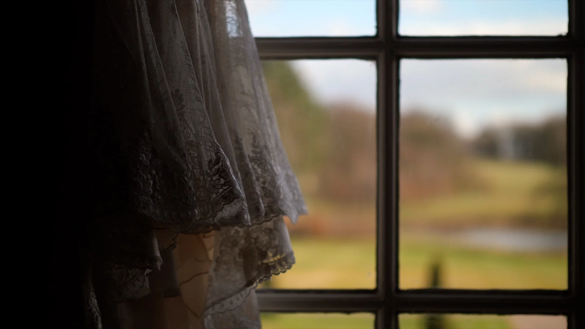 North West Wedding Videographer captures Jen’s Wedding Dress hangs in the window at Knowsley Hall.