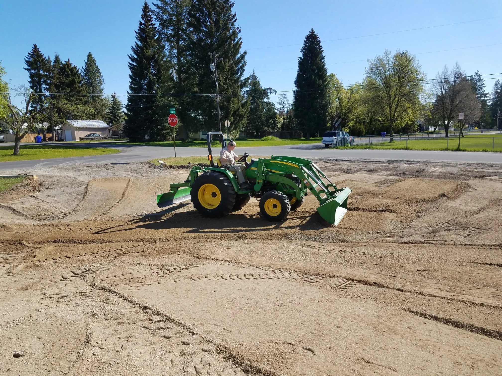 Jeff Hickethier donated his tractor and time to prep for paving by spreading the gravel to grade.