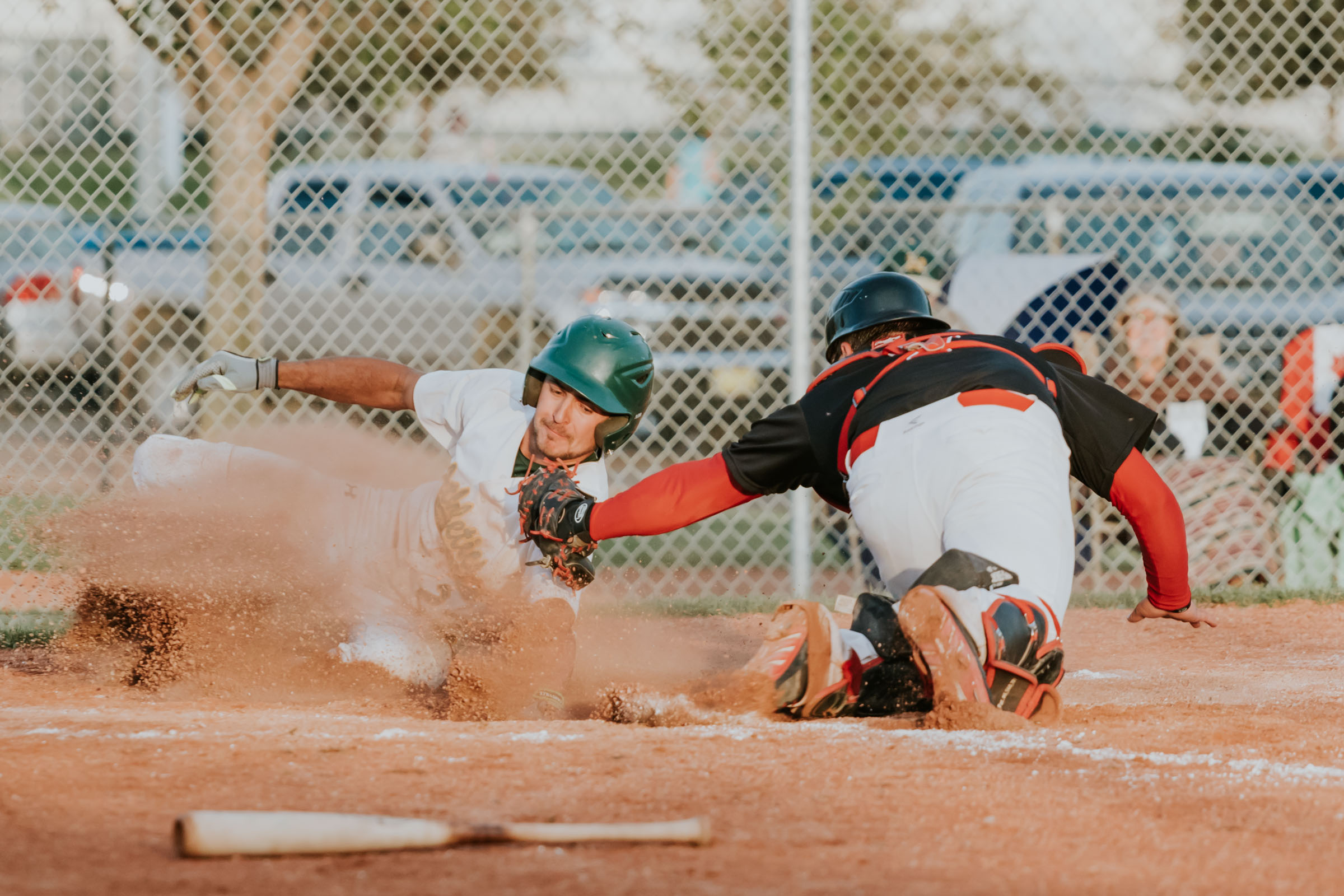 Sherwood Park Athletics catcher Mike Falkins (white) would be thrown out twice at home plate by Camrose Axemen centre fielder Jordan Riopel in the same game. This is a shot of the second time there was a play at the plate which was just before Falkins was ejected for arguing with the umpire | June 8 at Harry Andreassen Field, Camrose