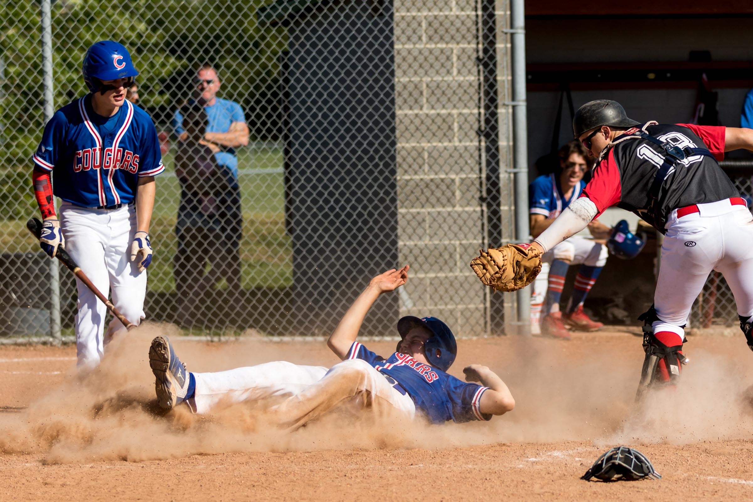 This was the winning run for the Camrose Cougars AA Midget team against the Edmonton Angels in the Midget AA Provincial Tournament. Lying almost completely on his back allowed the Cougars runner to avoid the tag of the Angels catcher | July 29 at Four Seasons Park, Beaumont