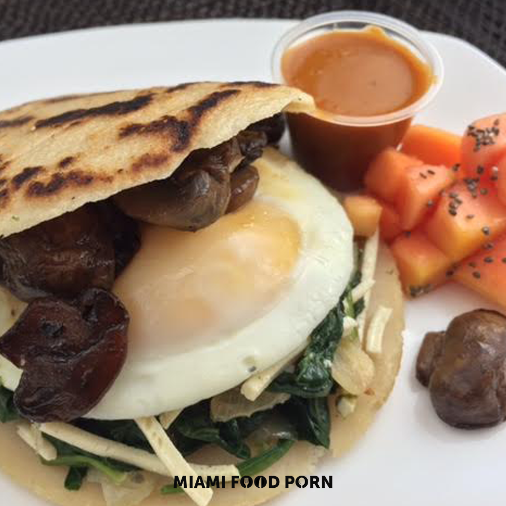 Arepa breakfast sandwich with sunny side up egg.