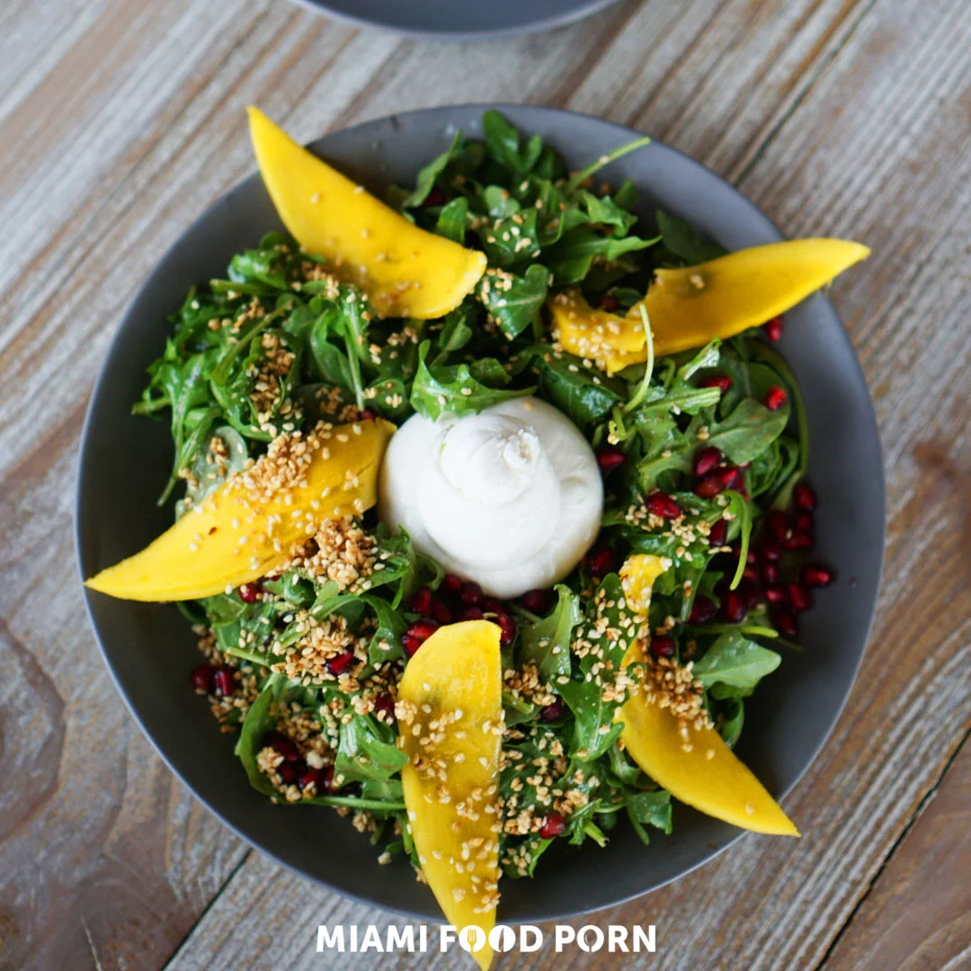 Burrata Fruit: Arugula, burrata, seasonal fruit, pomegranate, sesame seed brittle, maple balsamic
