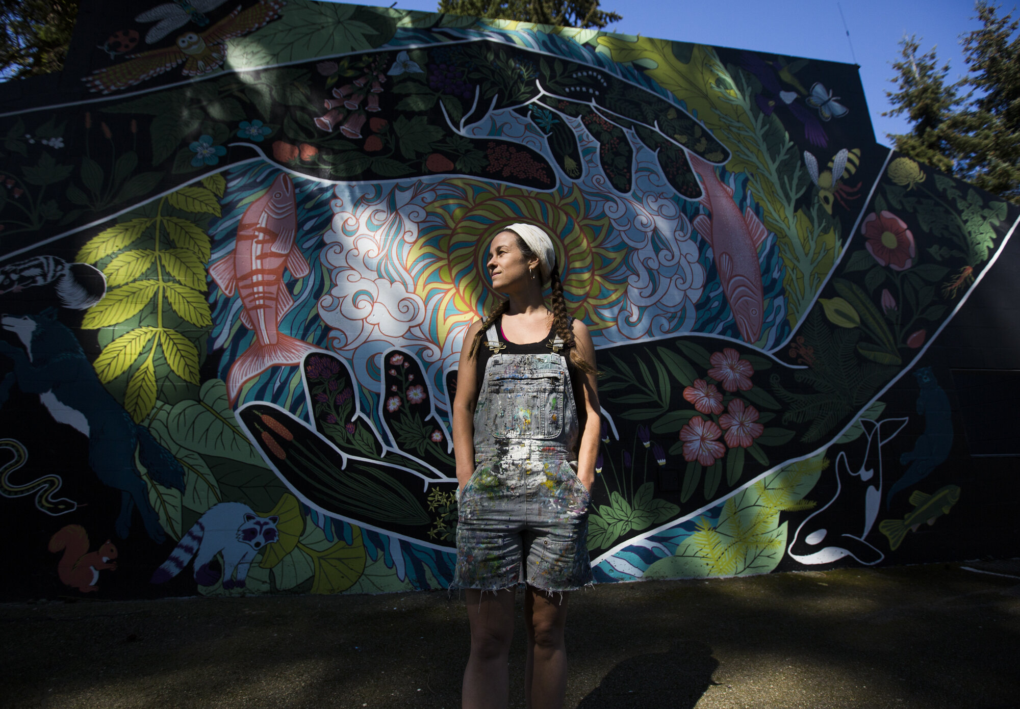  Seattle artist Gabrielle Abbott with her mural "Grateful Steward" at South Lynnwood Park on Wednesday, April 21, 2021 in Lynnwood, Wash. Fifty-four species are represented in Abbott’s work, with handful of them being local to the Lynnwood area speci