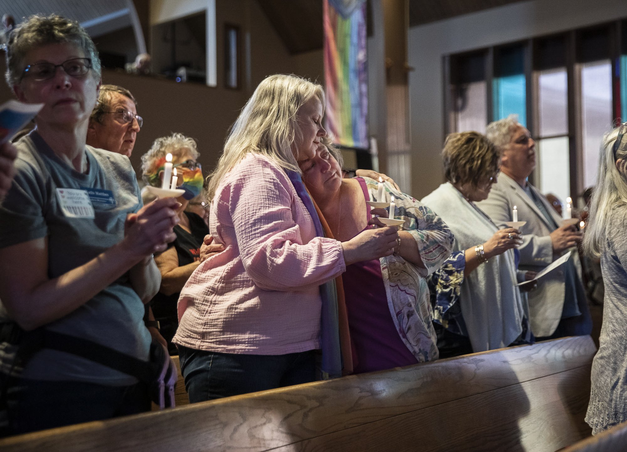  Anne Long, left, and Stacy Miller, right, embrace while singing "We Shall Overcome" during a vigil held to support the LGBTQIA+ community in response to the recent hate-filled incidents at two regional churches on Tuesday, May 2, 2023 in Edmonds, Wa