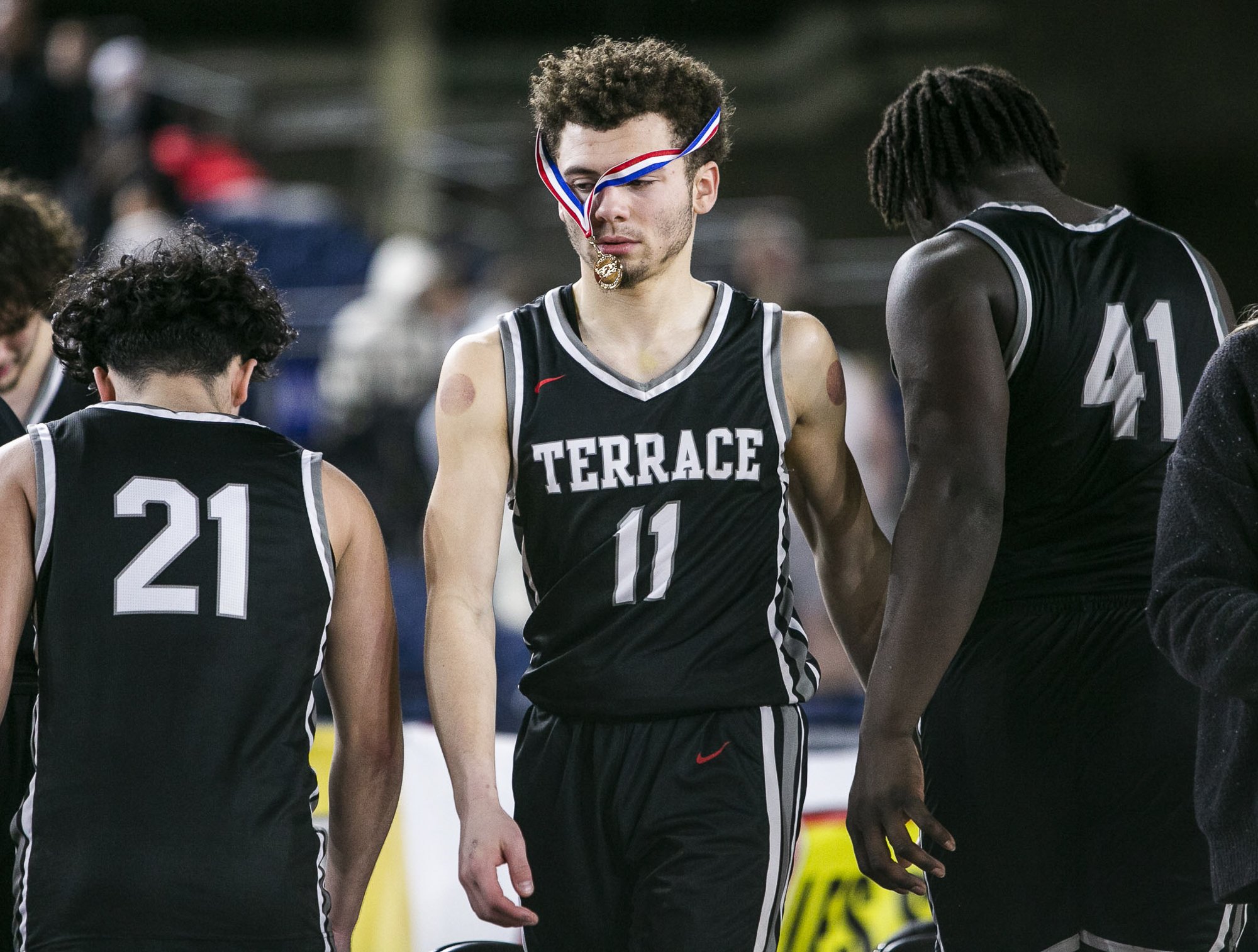  Mountlake’s Chris Meegan’s sportsmanship medal hangs over his face as his team packs up after losing to O’Dea in the 3A quarterfinal game on Thursday, March 2, 2023 in Tacoma, Washington. 