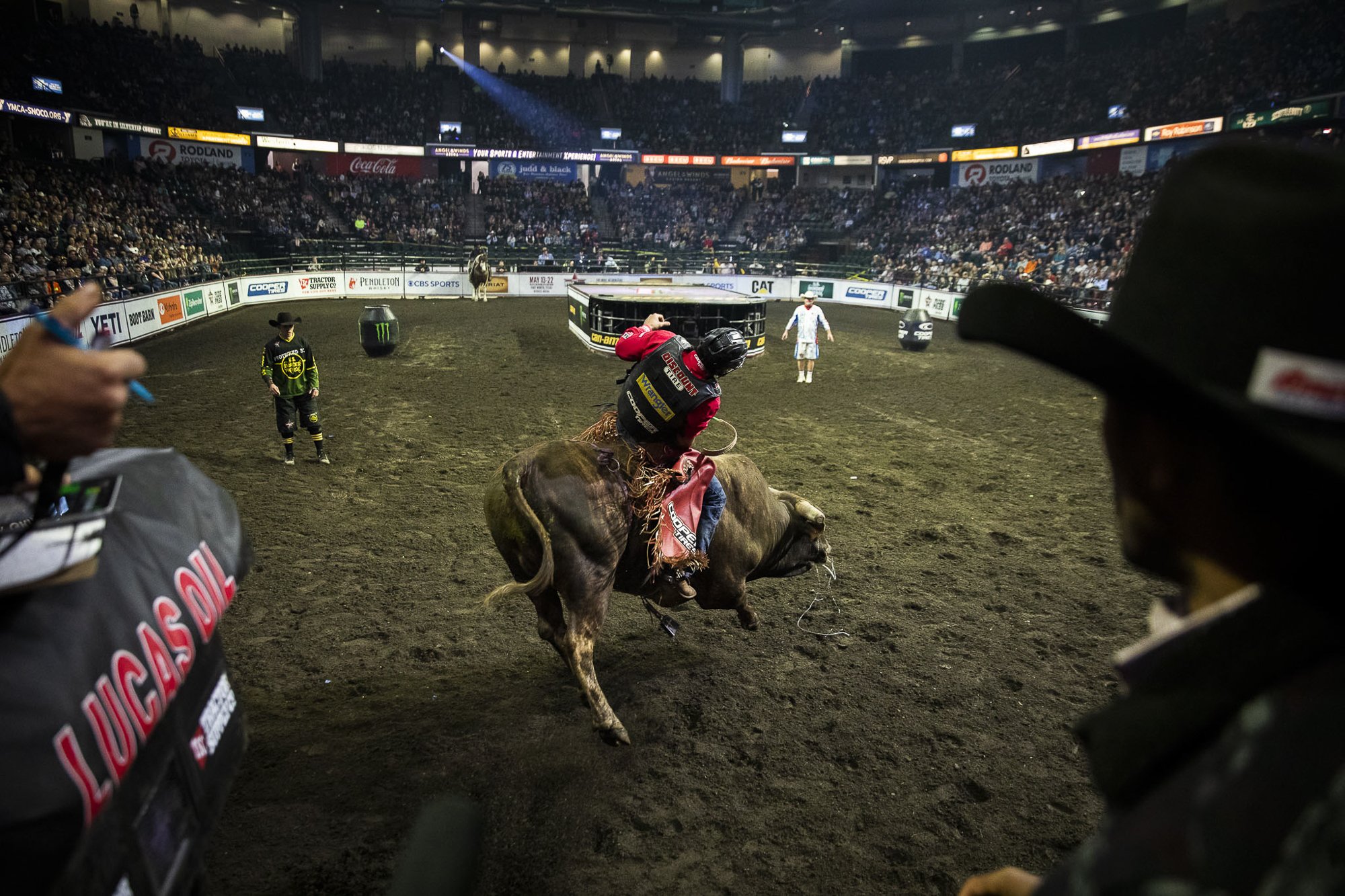  Silvano Alves rides his bull into the arena as the chute opens during the PBR Everett Invitational at Angel of the Winds Arena on April 6, 2022 in Everett, Washington.  