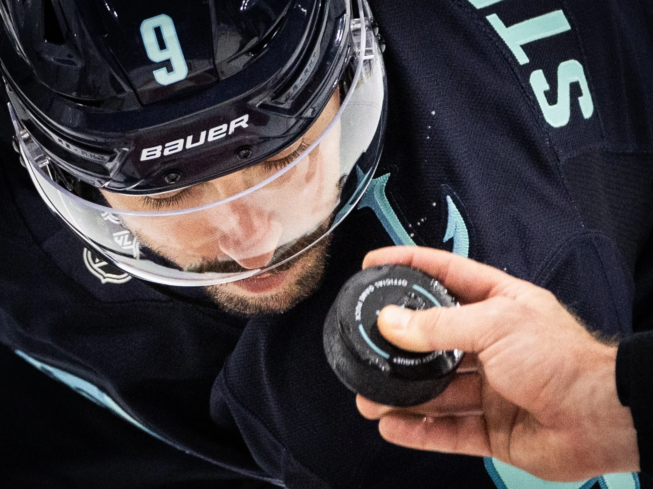  Water droplets fall off the puck as the referee drops the puck during a face off between Chandler Stephenson #9 of the Seattle Kraken and the Las Vegas Golden Knights at Climate Pledge Arena on October 11, 2025 in Seattle, Washington. (Olivia Vanni 
