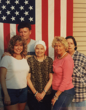 Patty's family in front of her father's flag. 
