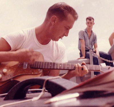 Patty's father, Jack Young, playing guitar with his band "The Swerve Combo" aboard the USS Swerve.