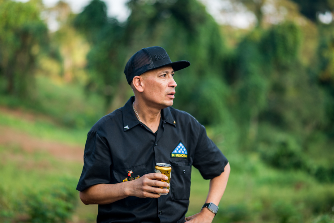 Ron Reyes overlooking his dad's site and drinking a beer in his honor.