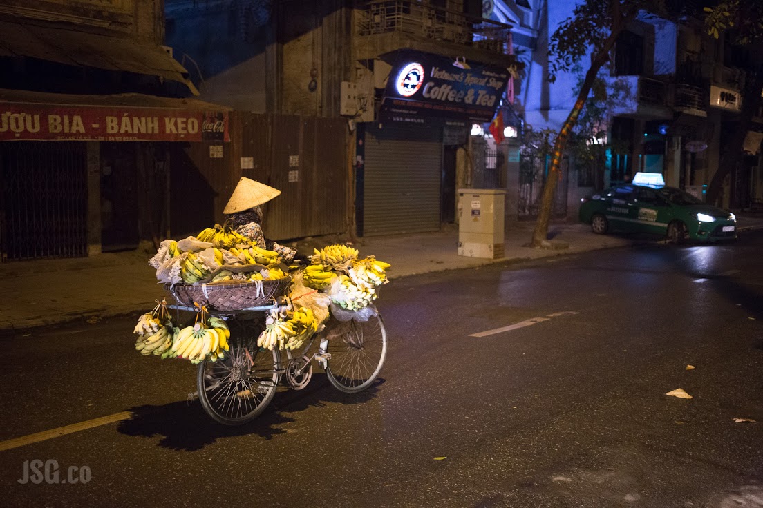 Bananas roll down the street at dawn in Hanoi. 