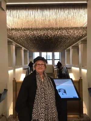 Susan in front of the dog tags exhibit, Chicago, 2018