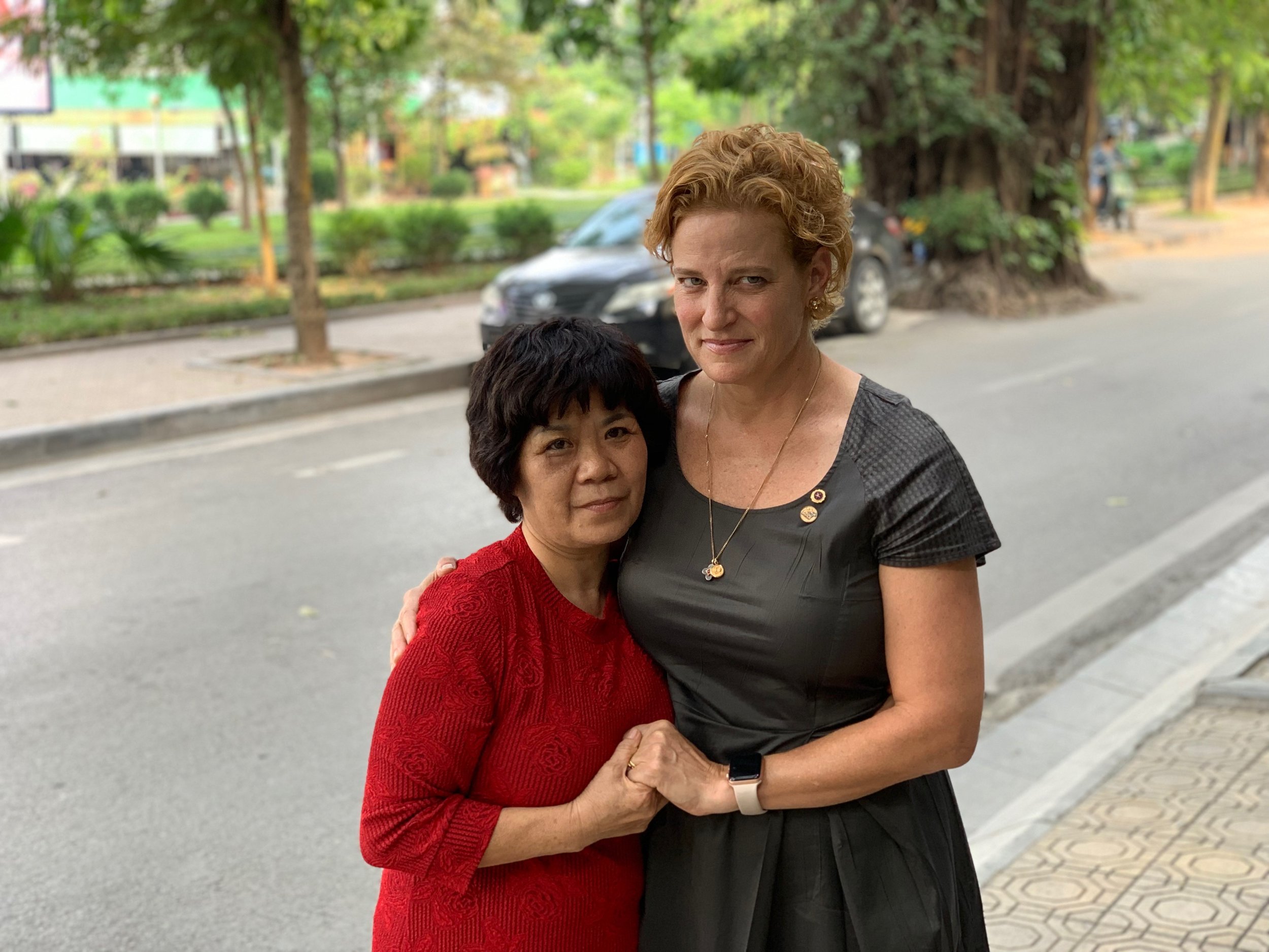 Nguyen Thi Luong and Margot Carlson Delogne. Luong’s mother was a kindergarten teacher who was in school one day when a bomb raid began. She rushed the children to the bomb shelter, and when she went to bring the last child to safety, a bomb hit. She protected the child with her body and lost her life. Margot’s father, a pilot, was shot down on December 7, 1966. He has remained missing for more than 50 years. What struck Margot most about Luong is how caring she was toward the American side. “She grasped our hands, embraced us warmly, held us close to her side. She was lovely, and loving.”
