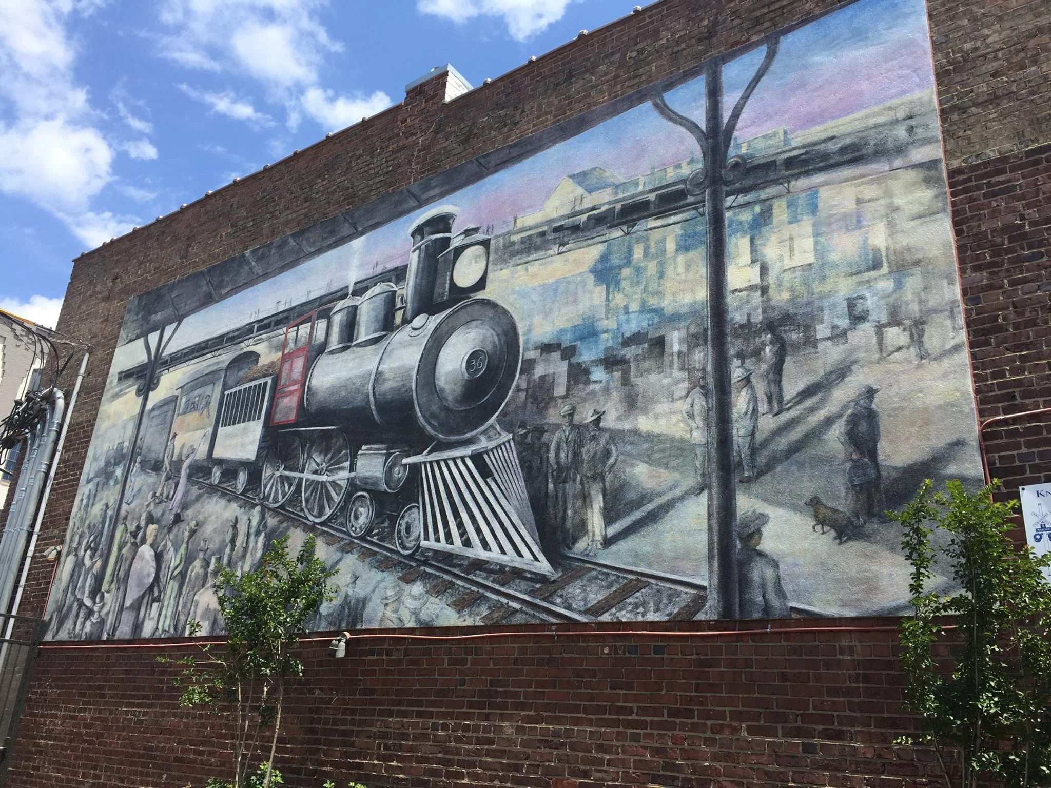 The Knoxville Historic Train Mural Located at 100 North Central Street, in the Lonesome Dove/Love Shack restaurant courtyard. The mural was first completed in 2002 and later restored in 2017 by artist Walt Fieldsa.