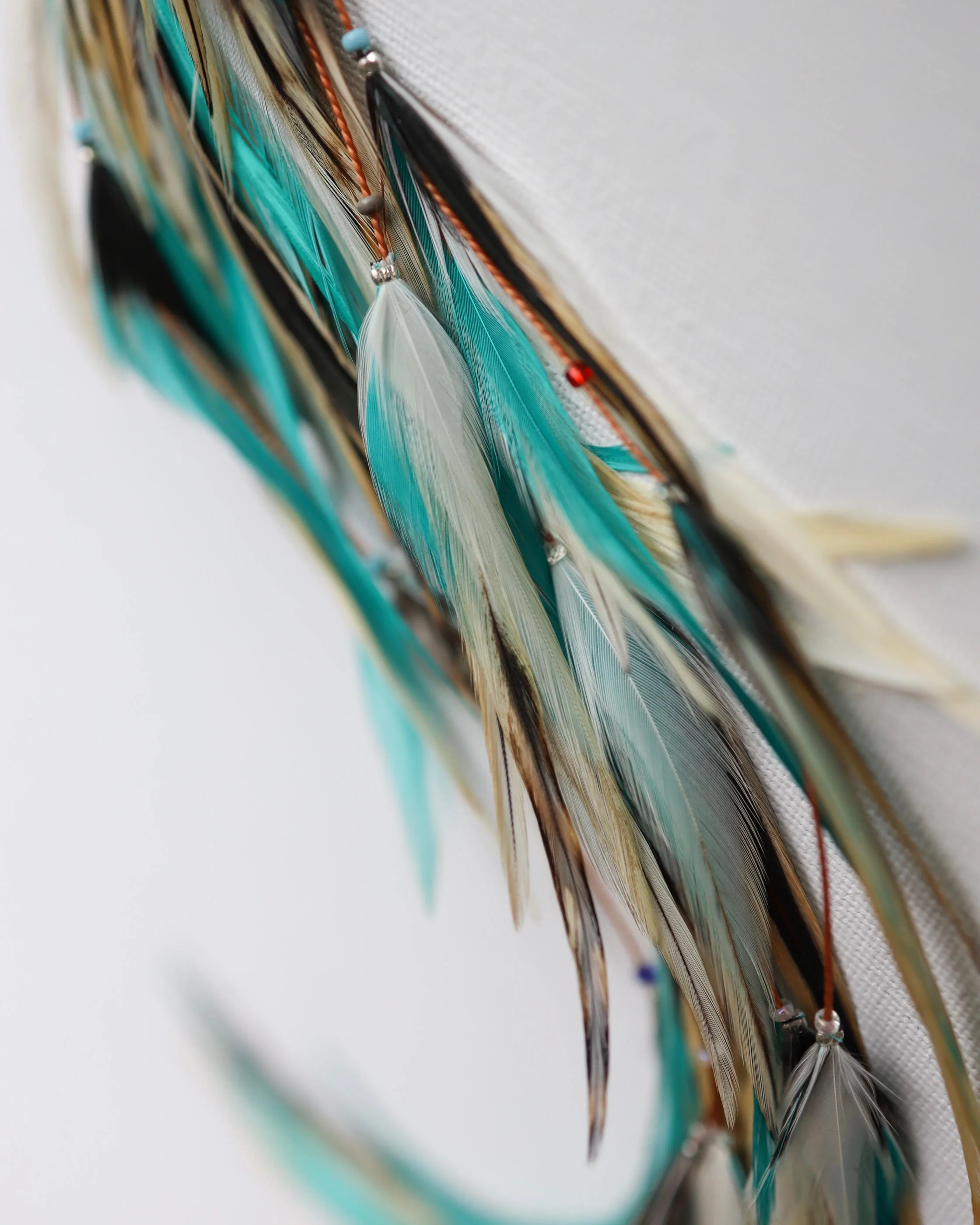light turquoise feather hair extensions macro.jpg