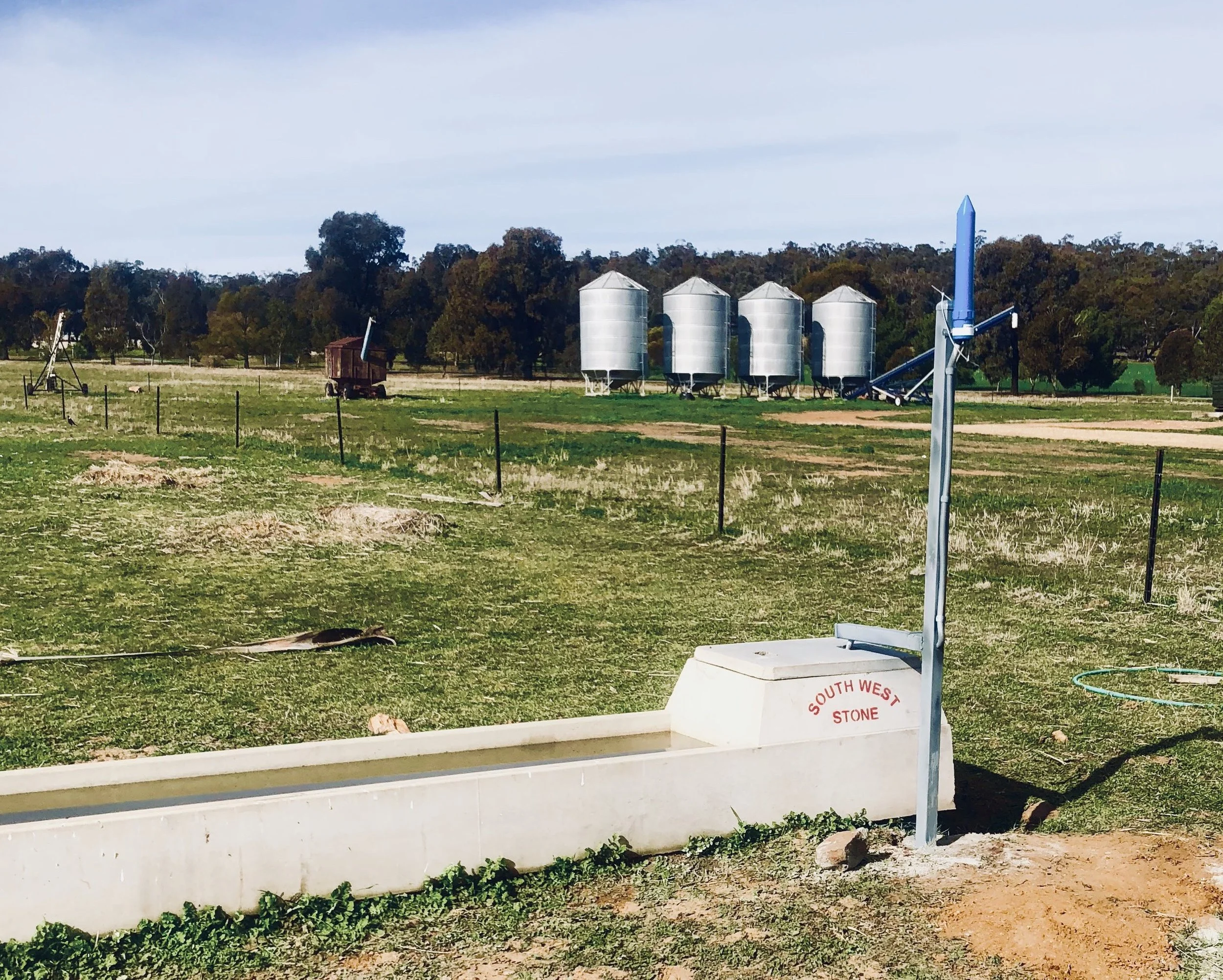 No, this farmer isn't letting off a small rocket - that little blue spaceship looking device is keeping an eye on the trough so he doesn't have to.