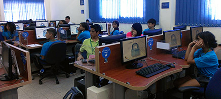 Students watch as Kolber demonstrates the features of Microsoft Publisher. Kolber explains the ins and outs of creating a newsletter.