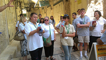The tour guide pauses to explain symbology in the local architecture.