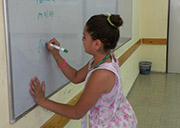 Mariam writes her name on the board in Tourism class, taught by Ms. Kochav. The trickiest part of today's class was learning the proper enunciation of "Annunciation."