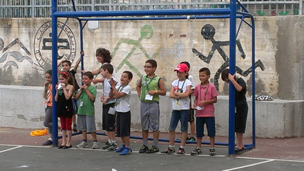 Grade 2 is poised and ready to run across the court in Sports as Spencer leads a variation on the game of tag. It's not often you have volunteers to be "it," but in this case every hand went up.