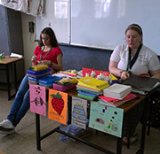 Missy reigns supreme as Arts and Crafts master while Grade 7 students adorn colorful drawings with an unlikely decoration: buttons.
