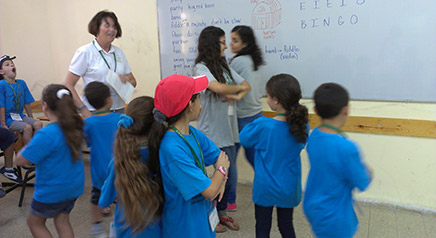 Campers and JCs (Rawan Nseir and Rawan Dahamshy) do-ci-do in Mary Marsh’s music class.